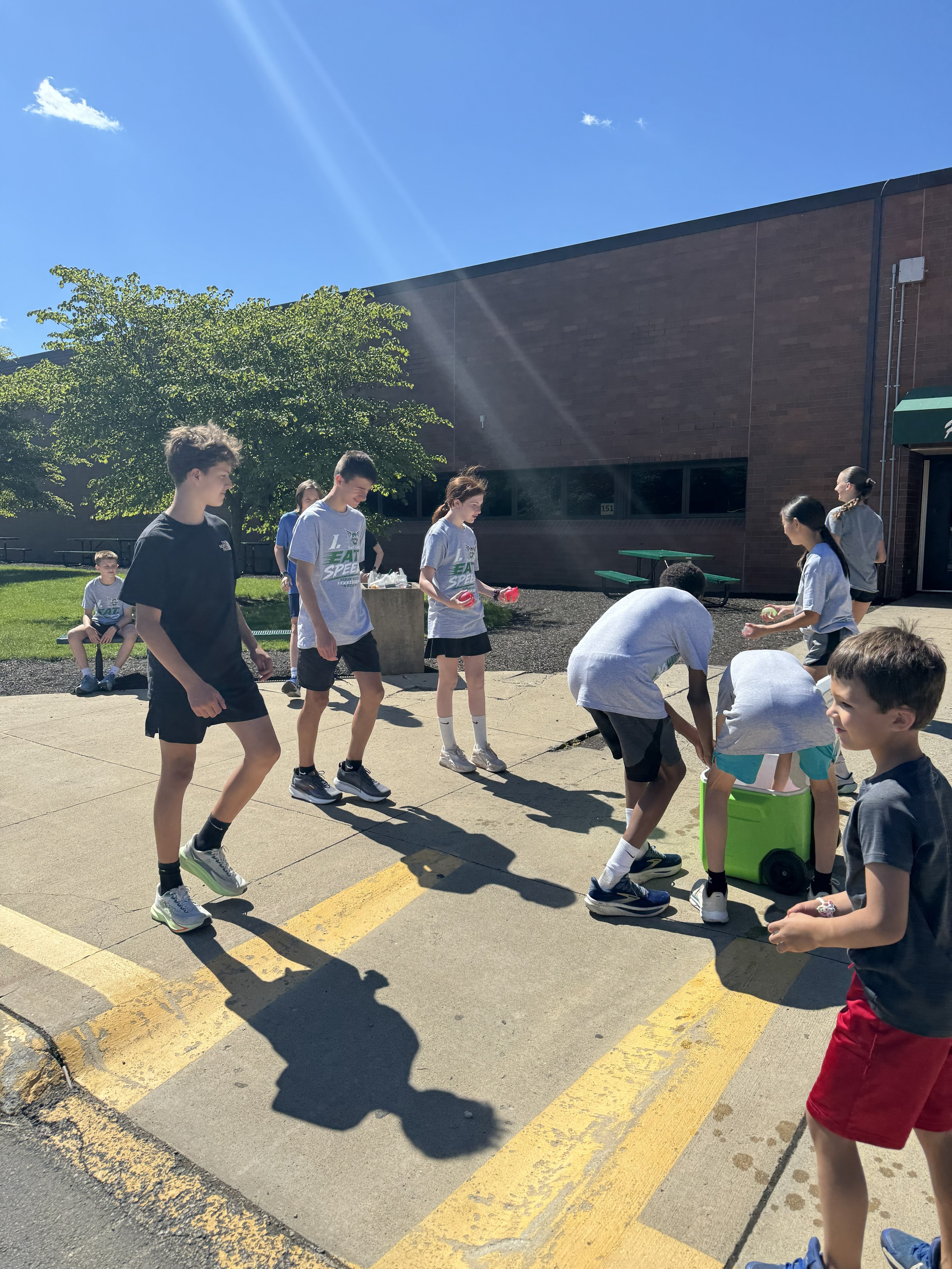 Larger group of campers playing water balloon games outside