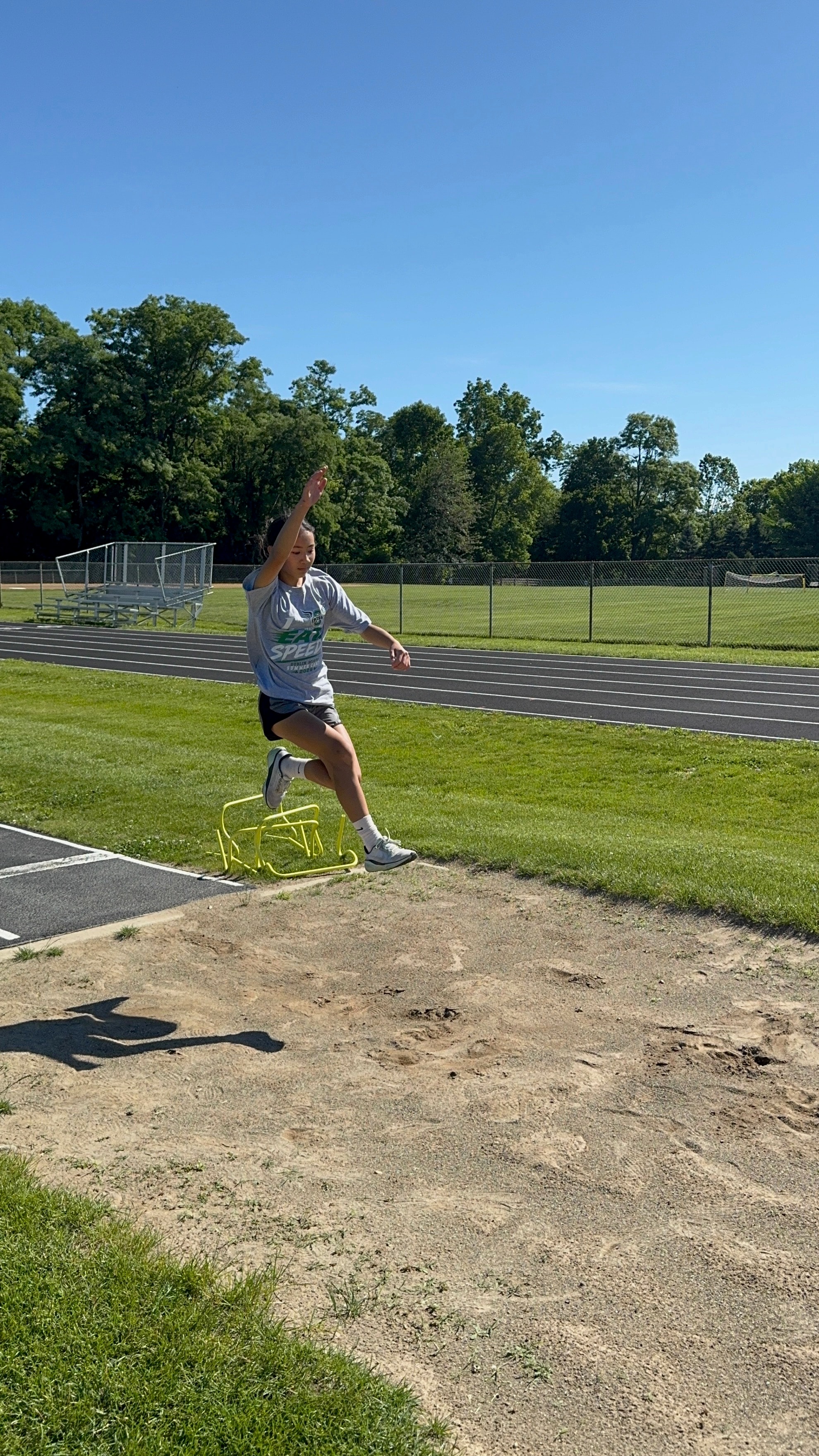 Camper soaring through the air in the long jump