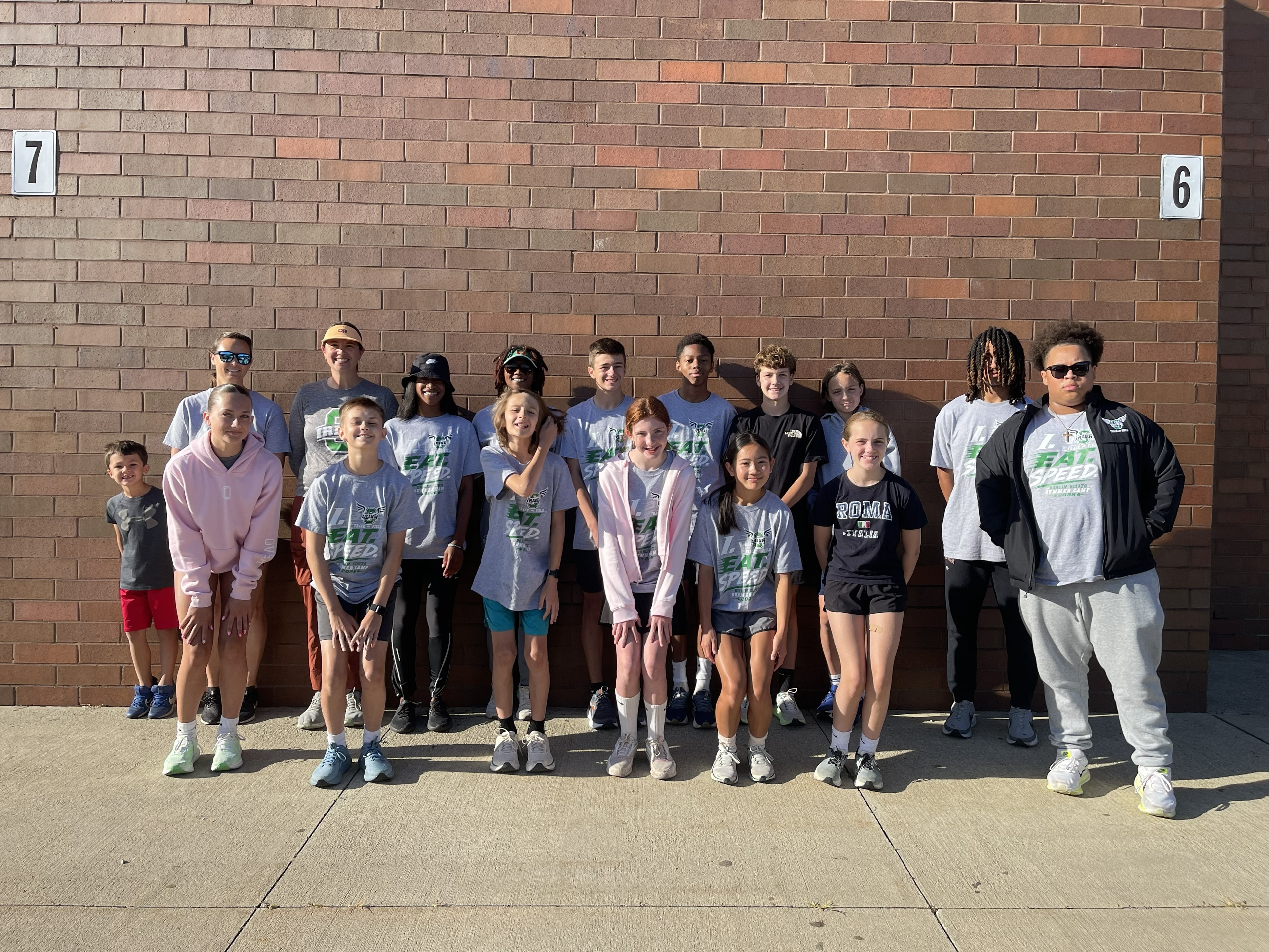 Summer camp group photo in front of the school