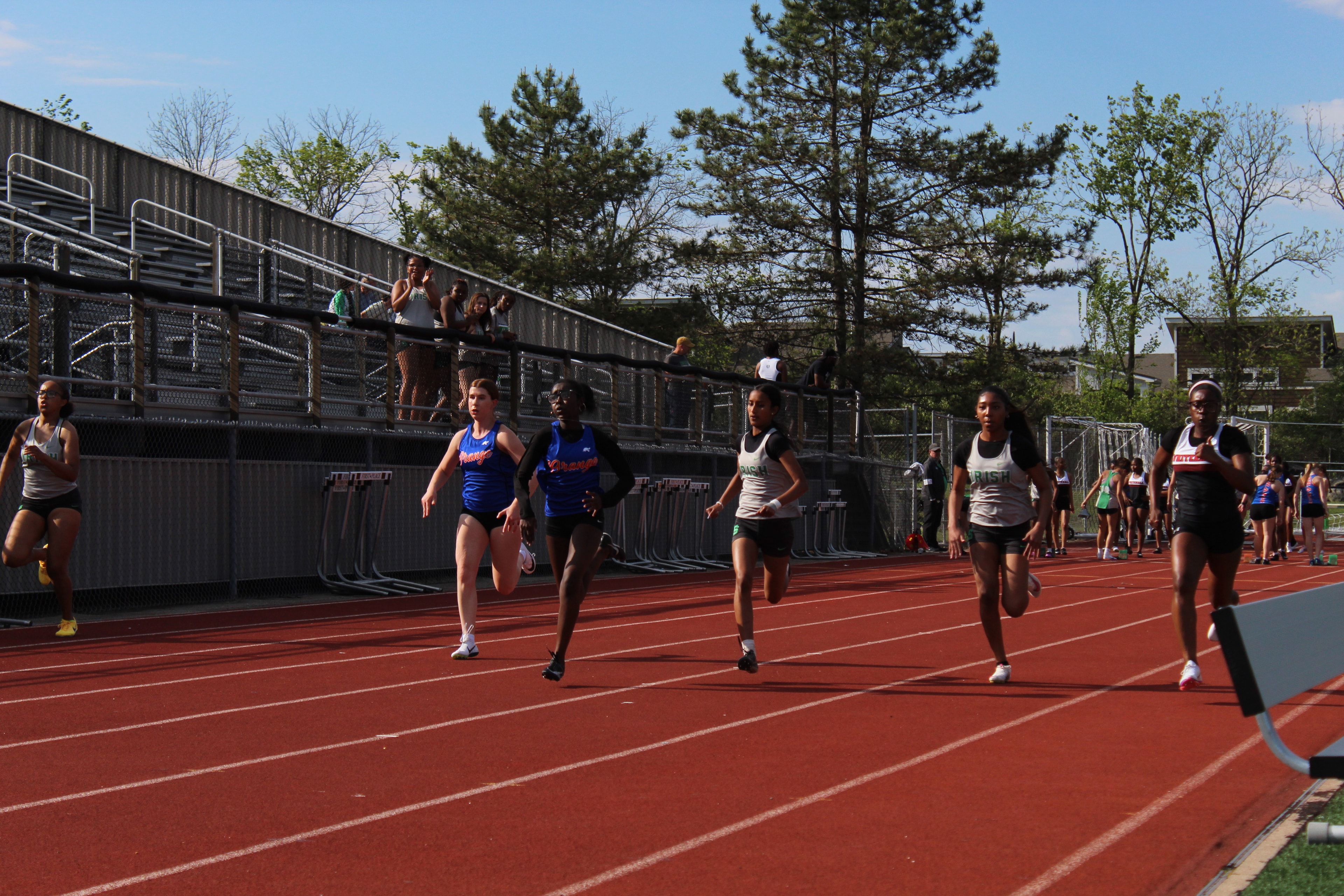 Irish girls sprinting on the track at a home meet
