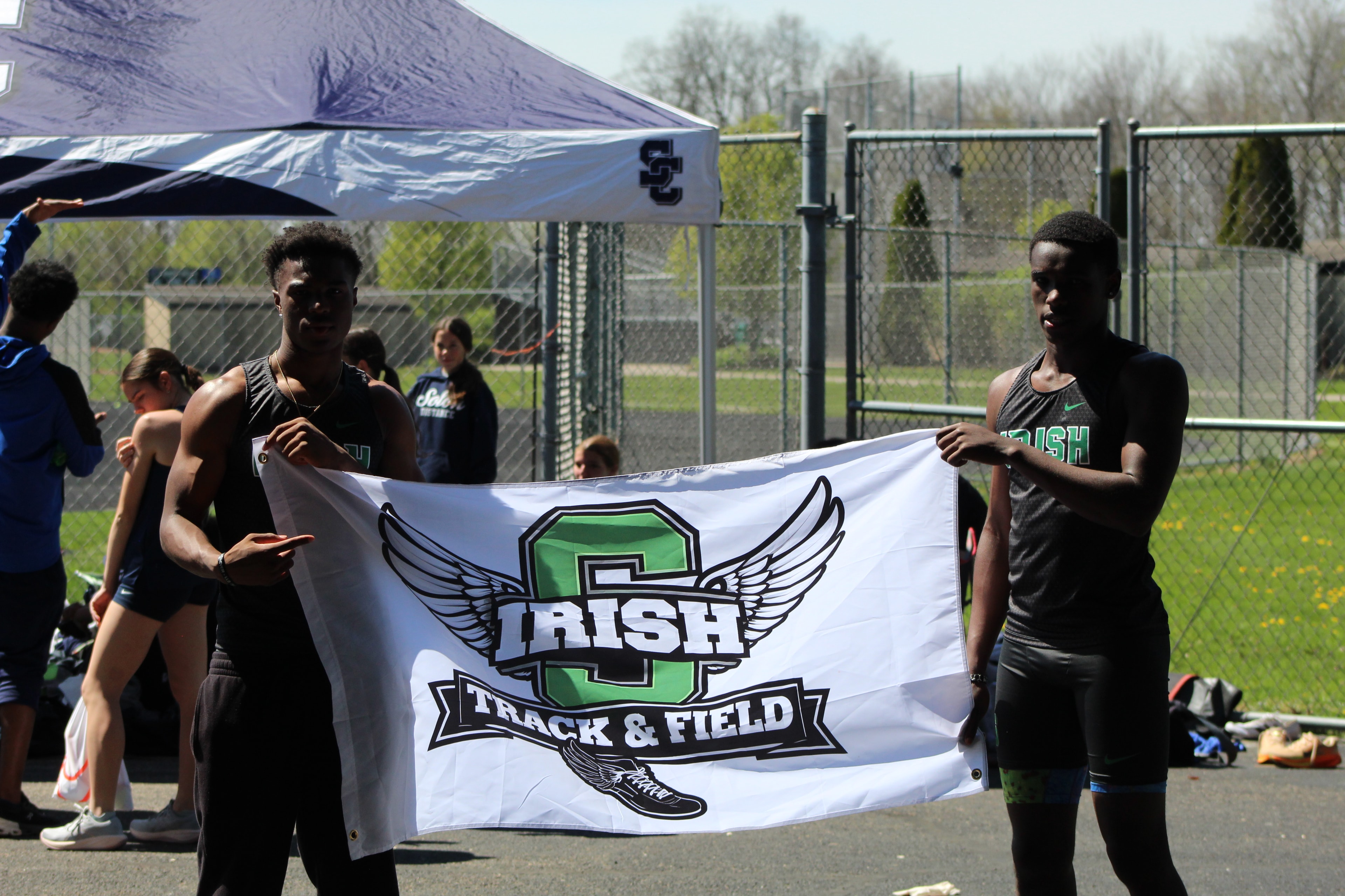 Scioto Irish athletes holding the team banner