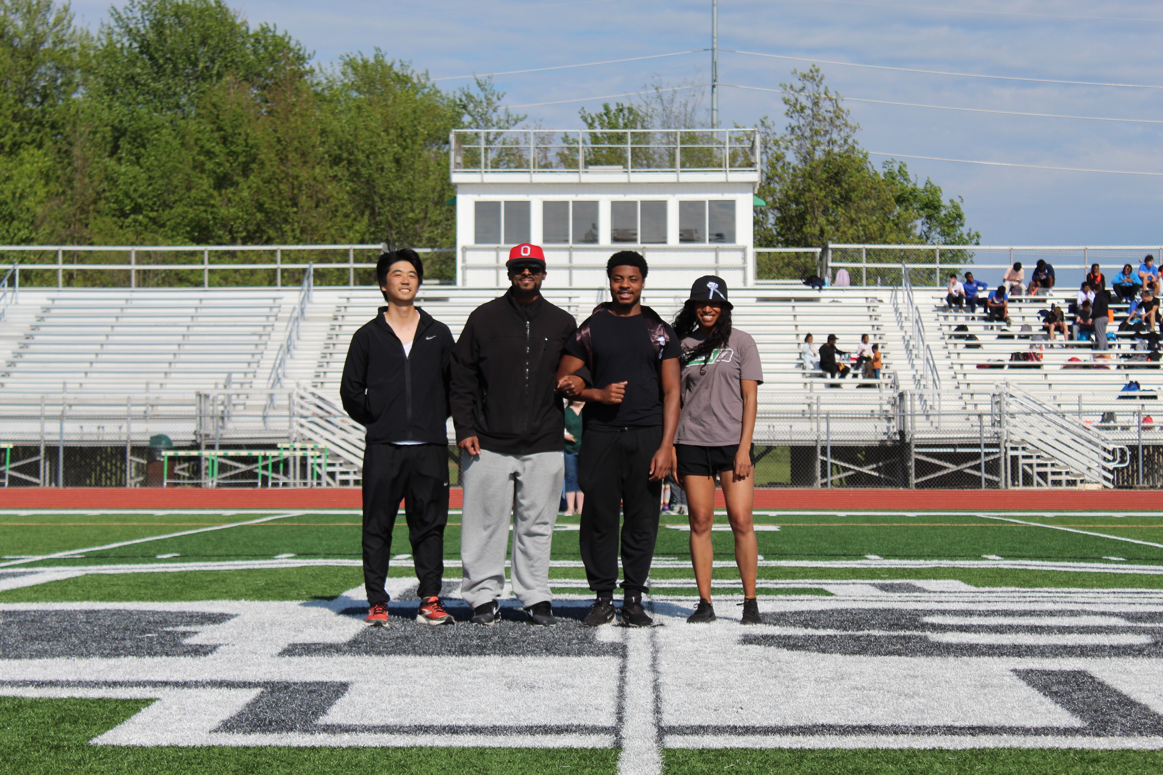 Senior with family on the field during Senior Night ceremony